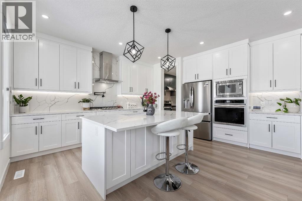 Vinyl Plank Flooring Throughout - 27 Bridges Drive, Langdon, AB - Indoor Photo Showing Kitchen With Stainless Steel Kitchen With Upgraded Kitchen