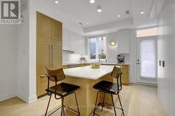 Custom kitchen cabinetry & entry to rear terrace -