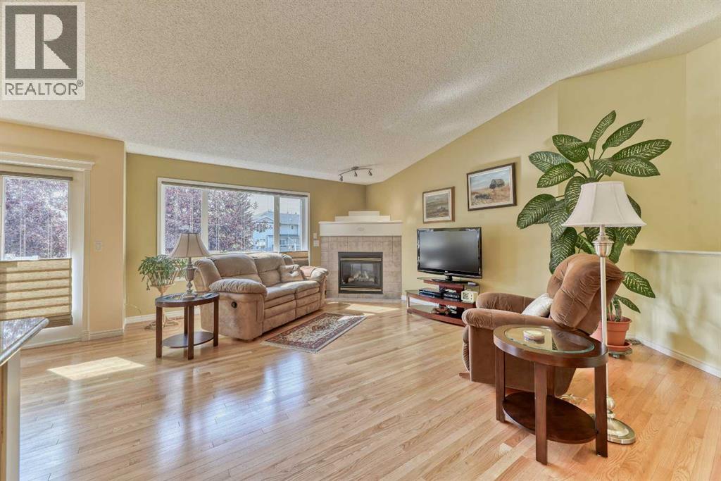 7 Scotia Landing Nw, Calgary, AB - Indoor Photo Showing Living Room With Fireplace