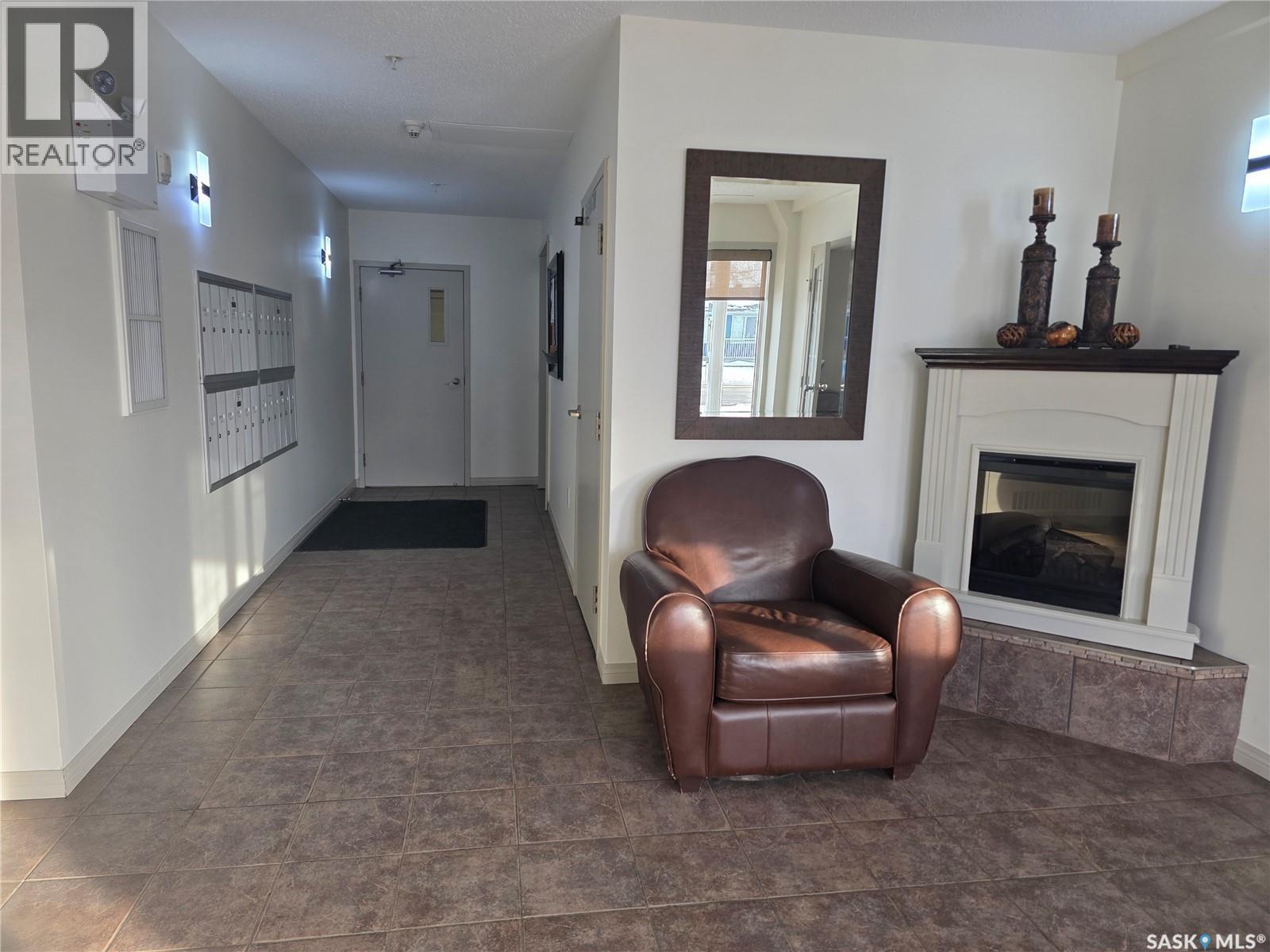 205 701 Henry Street, Estevan, SK - Indoor With Fireplace