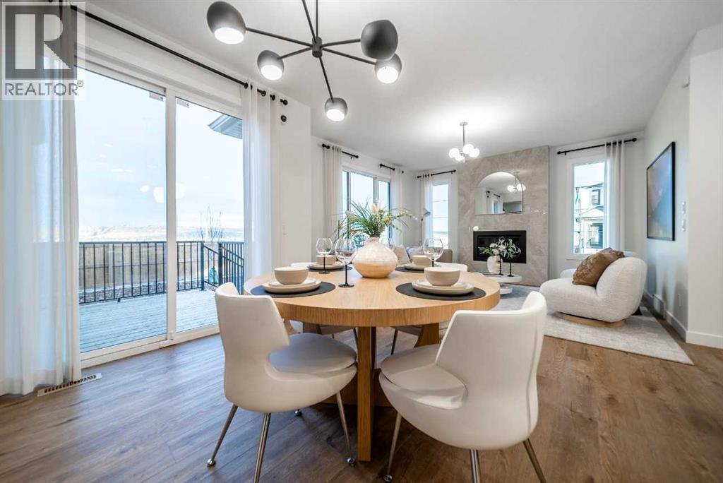 132 Southbow Village Way, Cochrane, AB - Indoor Photo Showing Dining Room With Fireplace