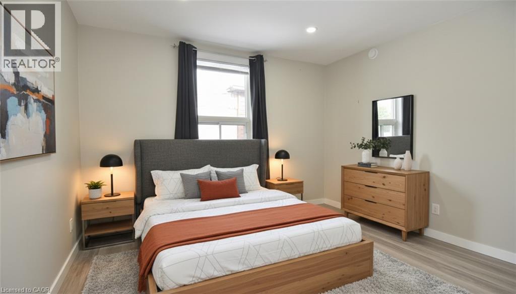 Bedroom featuring light wood-type flooring, multiple windows, and recessed lighting - 371 Fairfield Avenue, Hamilton, ON - Indoor Photo Showing Bedroom