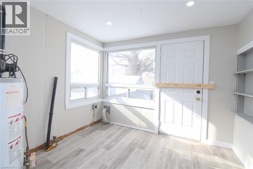 Washroom with hookup for an electric dryer, gas water heater, light wood-style floors, and recessed lighting - 371 Fairfield Avenue, Hamilton, ON - Indoor Photo Showing Other Room
