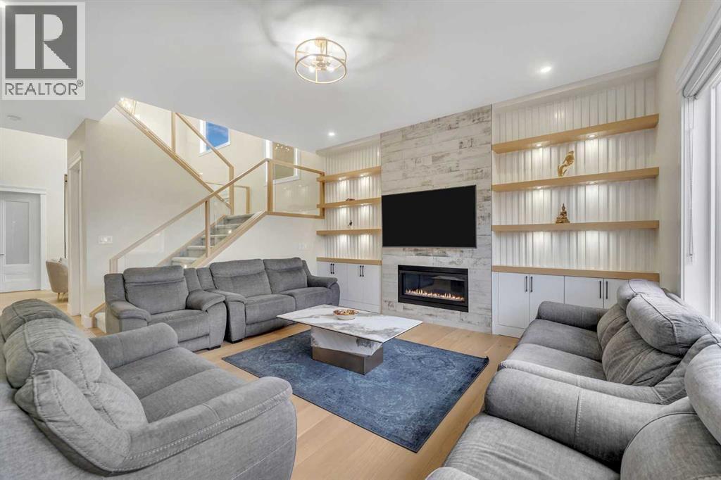 2012 Waterbury Road, Chestermere, AB - Indoor Photo Showing Living Room With Fireplace