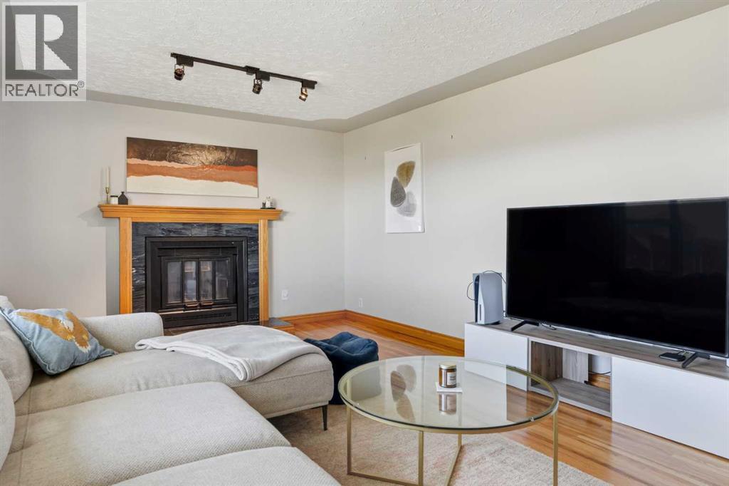 3003 25 Street Sw, Calgary, AB - Indoor Photo Showing Living Room With Fireplace