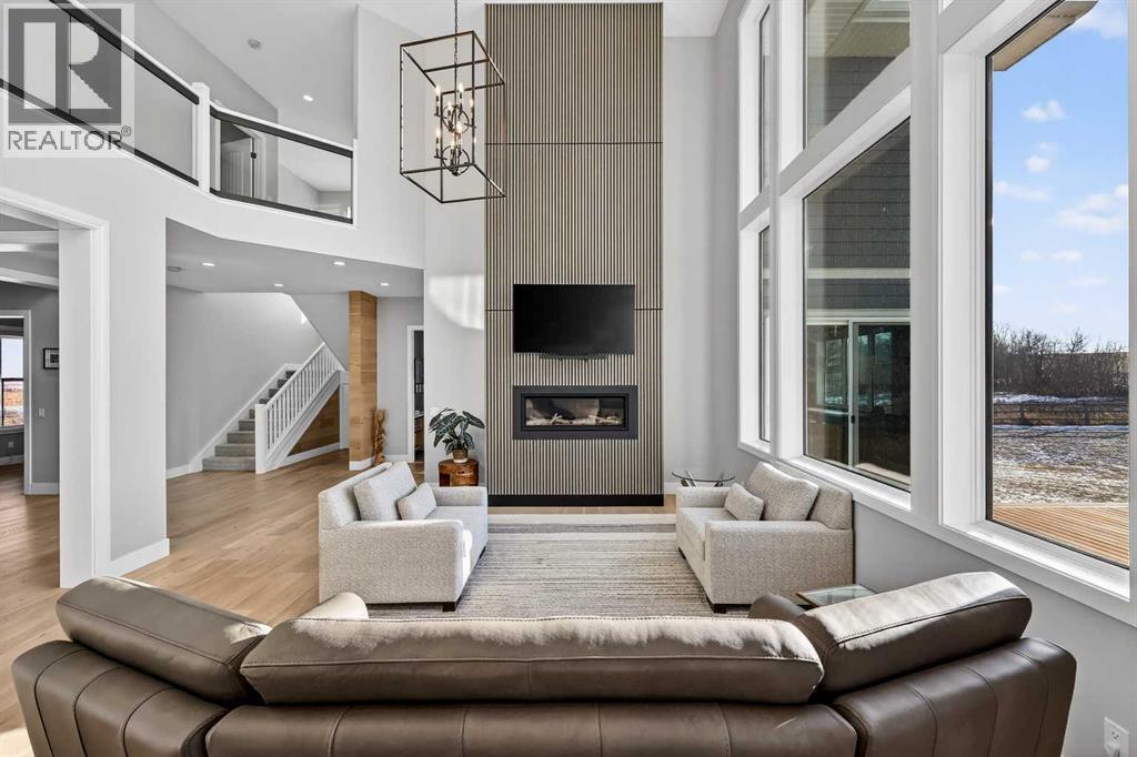 402017 23 Street W, Rural Foothills County, AB - Indoor Photo Showing Living Room With Fireplace