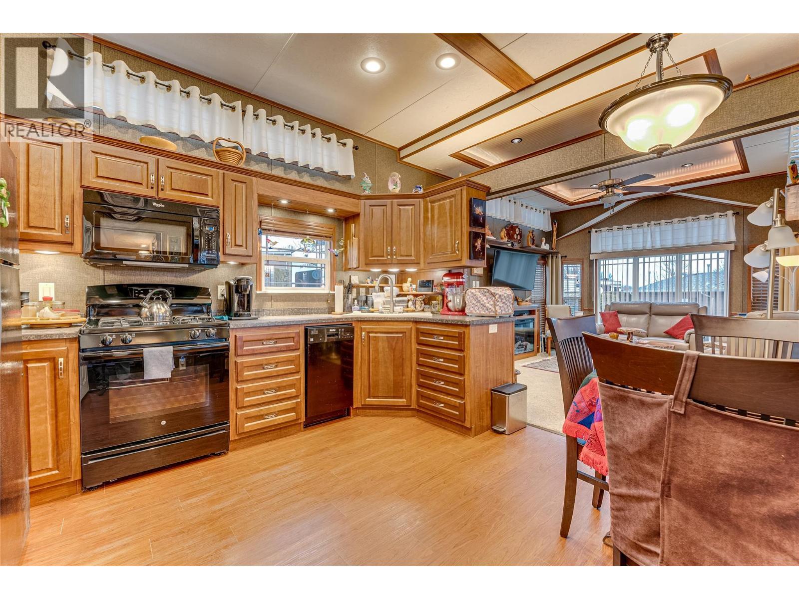 Lots of cabinets in your functional kitchen - 8000 Highland Road Unit# 42, Vernon, BC