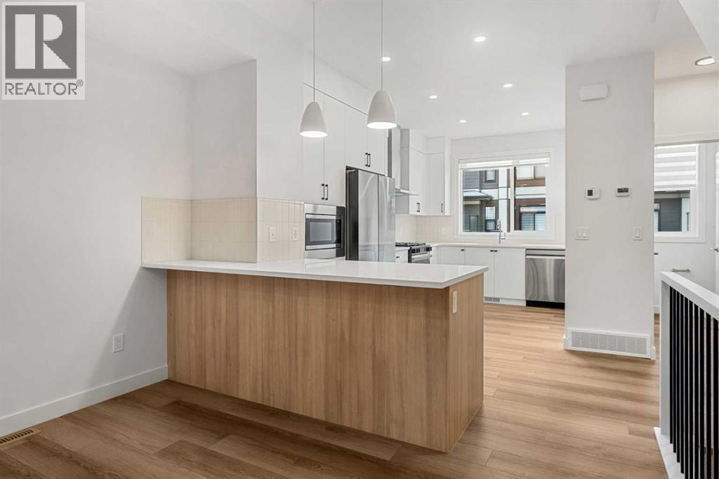 203, 550 Seton Circle Se, Calgary, AB - Indoor Photo Showing Kitchen With Upgraded Kitchen