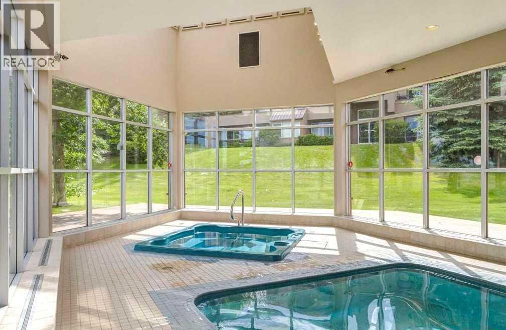 1, 101 Village Heights Sw, Calgary, AB - Indoor Photo Showing Other Room With In Ground Pool
