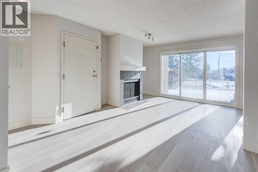 1, 101 Village Heights Sw, Calgary, AB - Indoor With Fireplace