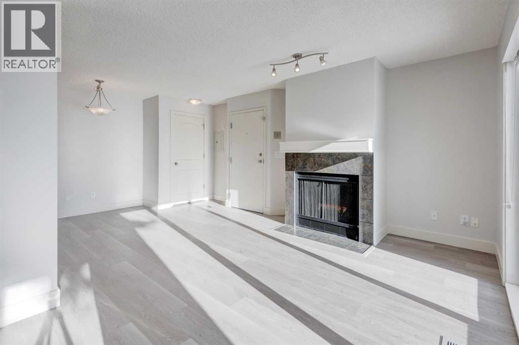 1, 101 Village Heights Sw, Calgary, AB - Indoor With Fireplace