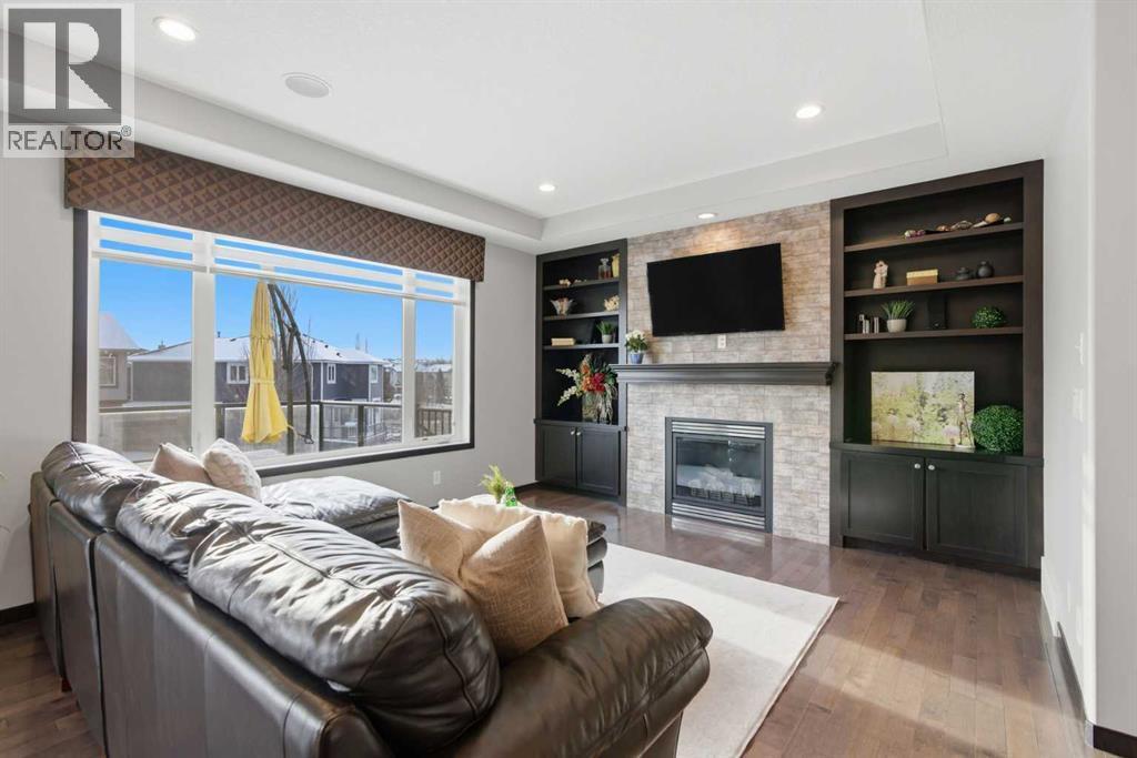 71 Panatella View Nw, Calgary, AB - Indoor Photo Showing Living Room With Fireplace