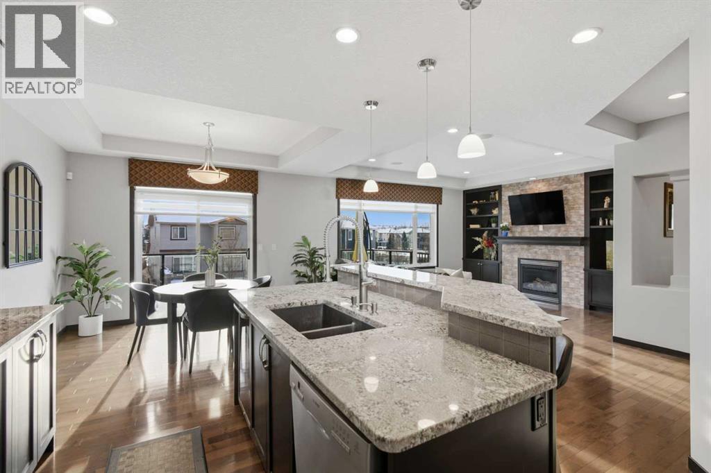 71 Panatella View Nw, Calgary, AB - Indoor Photo Showing Kitchen With Fireplace With Double Sink With Upgraded Kitchen