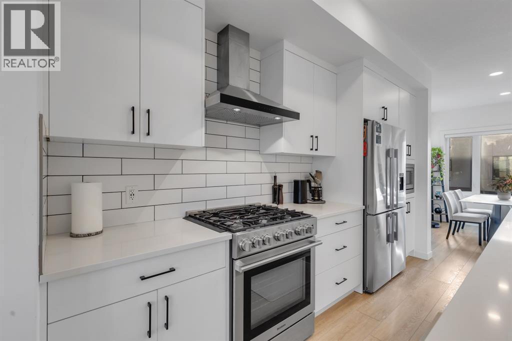 Upgraded Bricklay Backsplash - 213 Greenbriar Common Nw, Calgary, AB - Indoor Photo Showing Kitchen With Stainless Steel Kitchen With Upgraded Kitchen