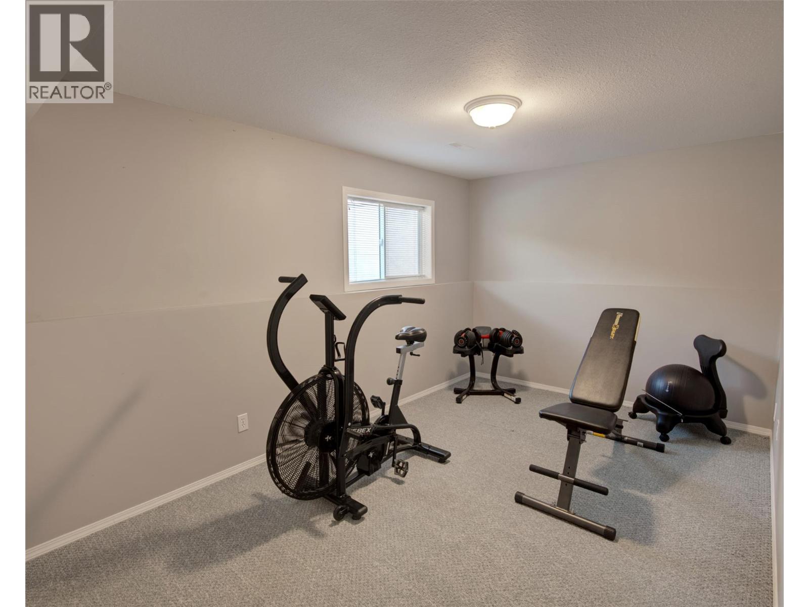 4th Bedroom on lower level with closets - 2312 Hunter Avenue, Armstrong, BC - Indoor Photo Showing Gym Room