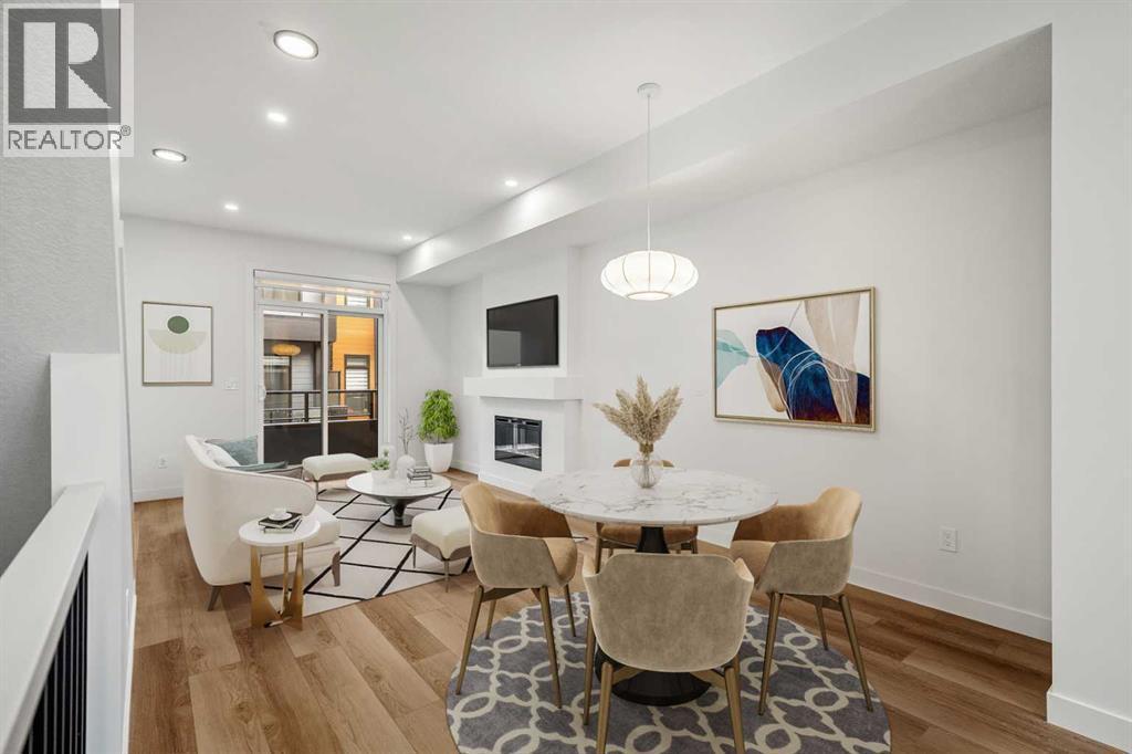 202, 550 Seton Circle Se, Calgary, AB - Indoor Photo Showing Dining Room With Fireplace