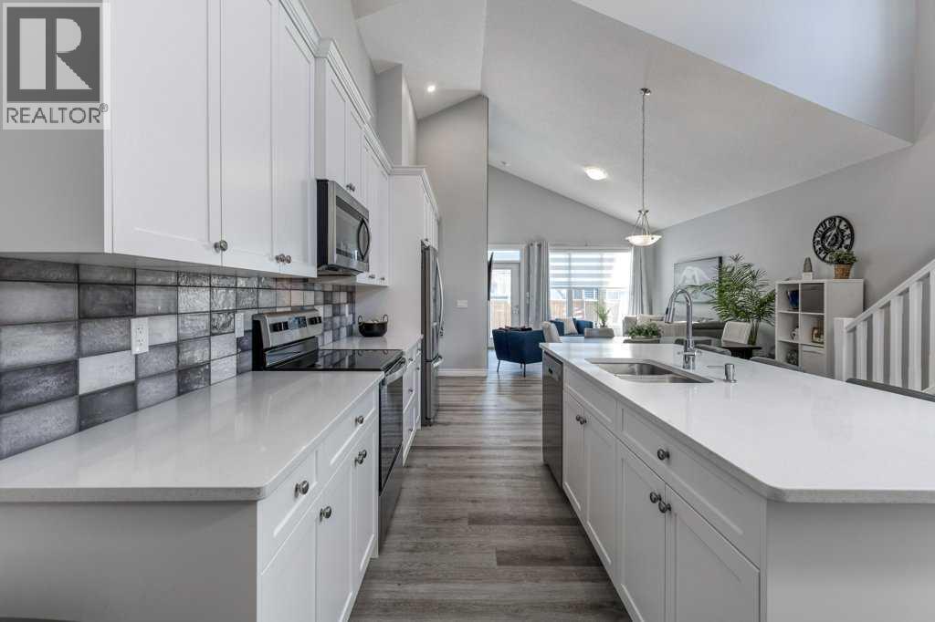 380 Rivercrest View, Cochrane, AB - Indoor Photo Showing Kitchen With Double Sink