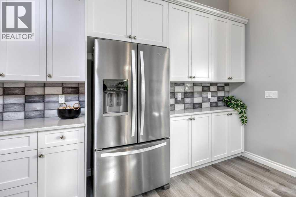 380 Rivercrest View, Cochrane, AB - Indoor Photo Showing Kitchen With Stainless Steel Kitchen