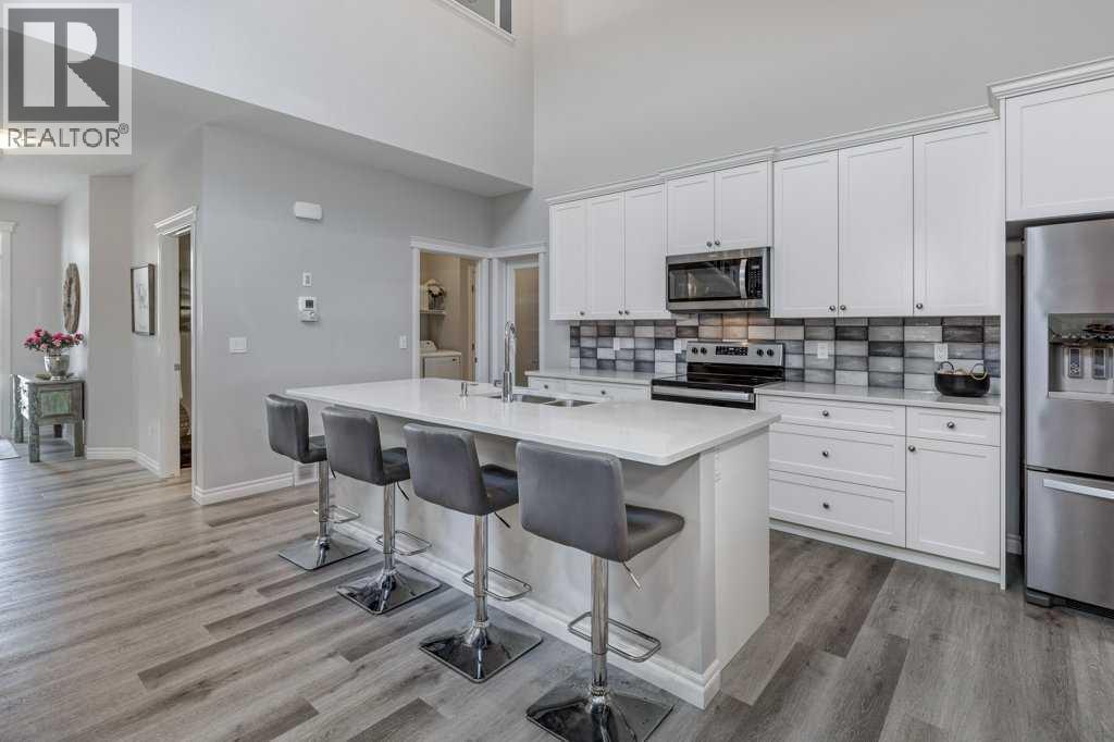 380 Rivercrest View, Cochrane, AB - Indoor Photo Showing Kitchen With Stainless Steel Kitchen