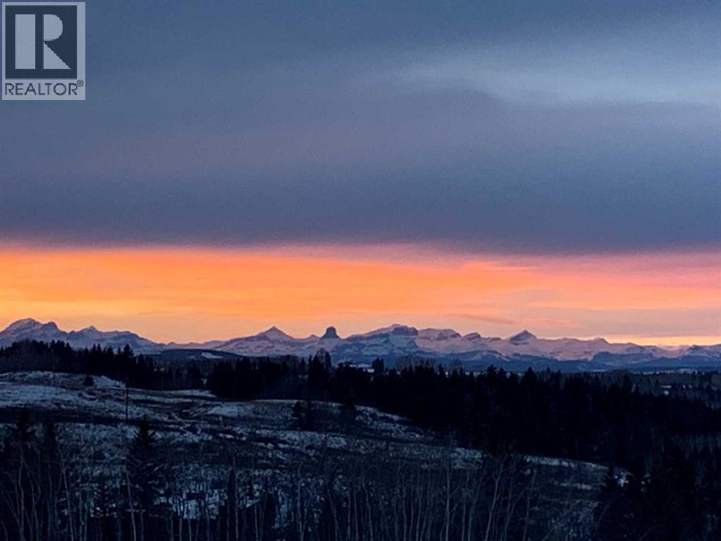 Gorgeous mountain sunsets - Devil's Head Mountain takes center stage in this upper level shot to the West - 380 Rivercrest View, Cochrane, AB - Outdoor With View
