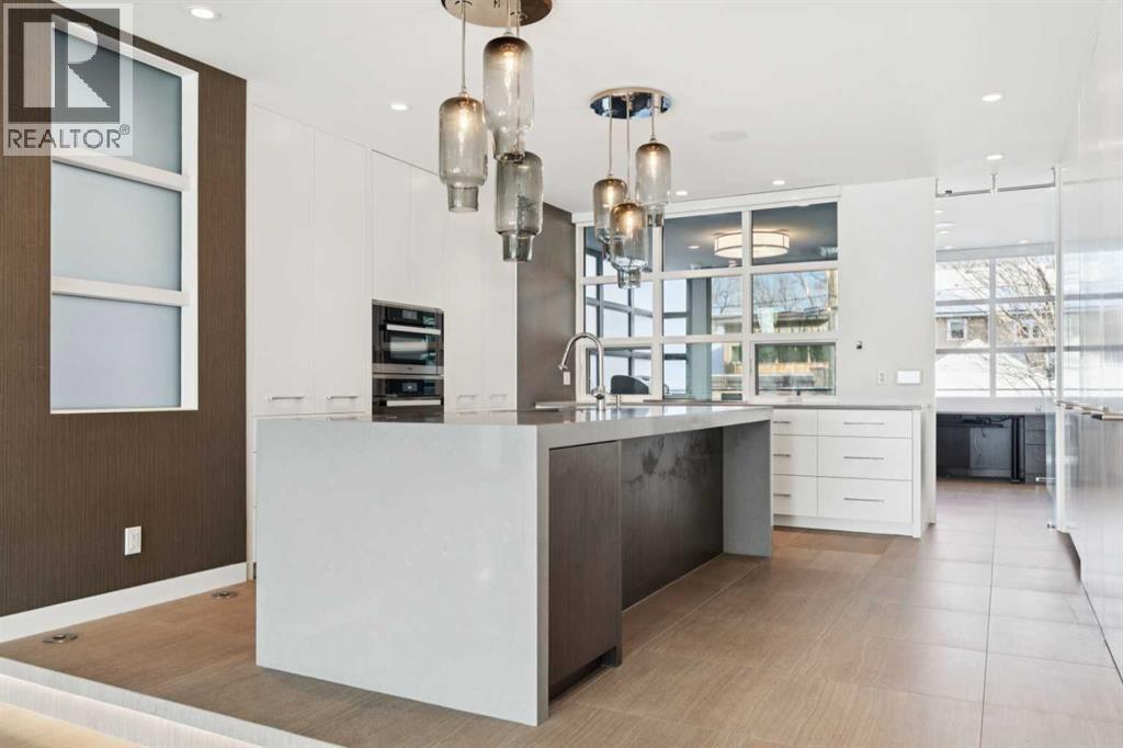 HIGH END CHEF'S KITCHEN WITH QUARTZ WATERFAL ISLAND - 530 Crescent Road Nw, Calgary, AB - Indoor Photo Showing Kitchen With Upgraded Kitchen