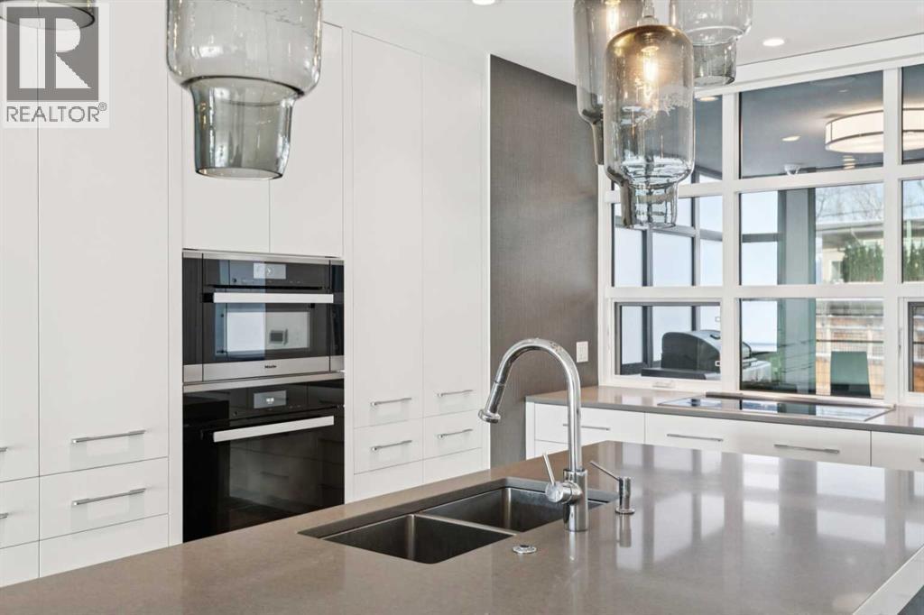 MIELE APPLIANCE PACKAGE: FULL-HEIGHT FRIDGE, FULL-HEIGHT FREEZER, INDUCTION COOKTOP WITH EXHAUST FAN, WALL OVEN, SPEED OVEN AND WARMING DRAWER - 530 Crescent Road Nw, Calgary, AB - Indoor Photo Showing Kitchen With Double Sink With Upgraded Kitchen