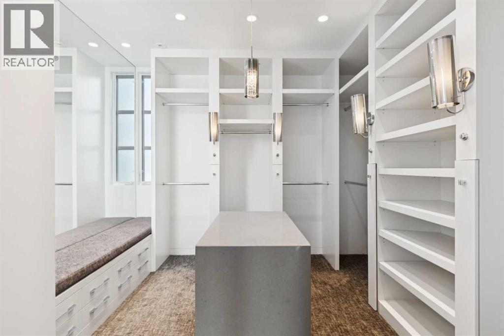 CUSTOM-DESIGNED WALK-IN CLOSET AND DRESSING ROOM. LOTS OF DRAWERS. ADDITIONAL BACK OF CLOSETS NOT SHOWN - 530 Crescent Road Nw, Calgary, AB - Indoor