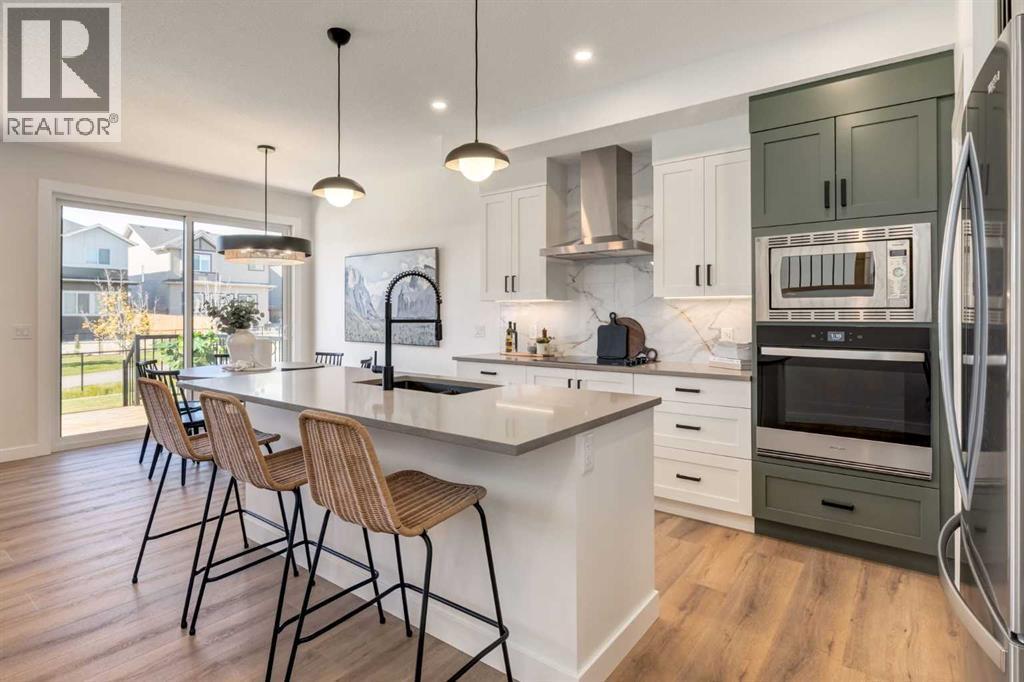 128 Quartz Crescent, Cochrane, AB - Indoor Photo Showing Kitchen With Stainless Steel Kitchen With Upgraded Kitchen