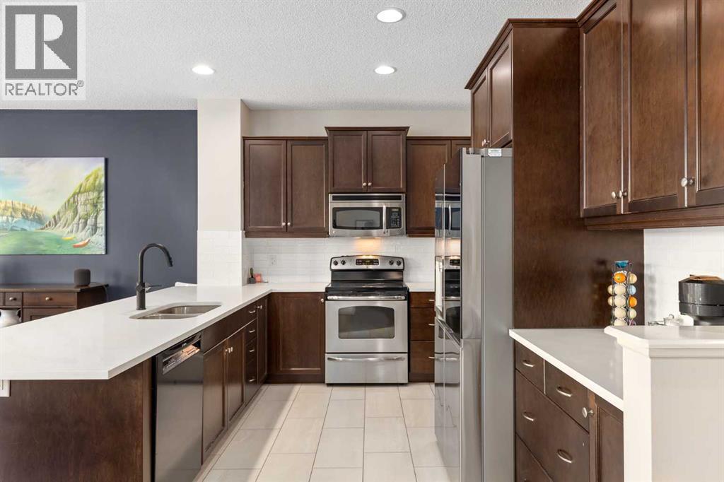 112 Sunset View, Cochrane, AB - Indoor Photo Showing Kitchen With Double Sink