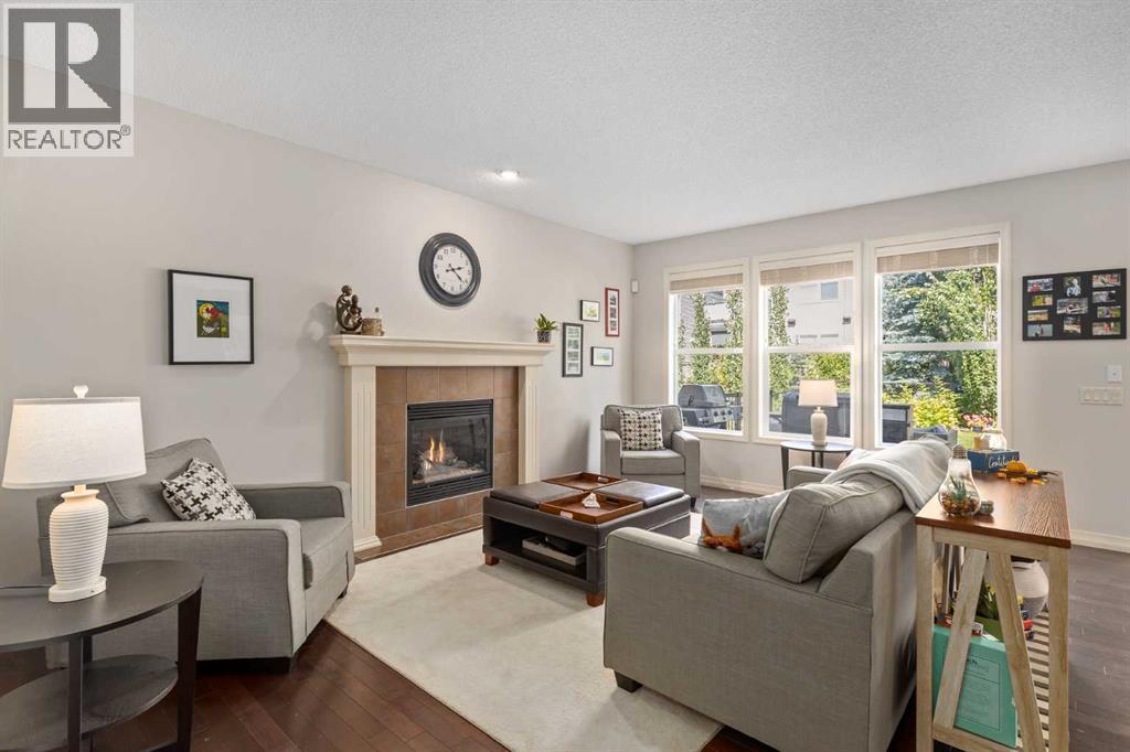 112 Sunset View, Cochrane, AB - Indoor Photo Showing Living Room With Fireplace