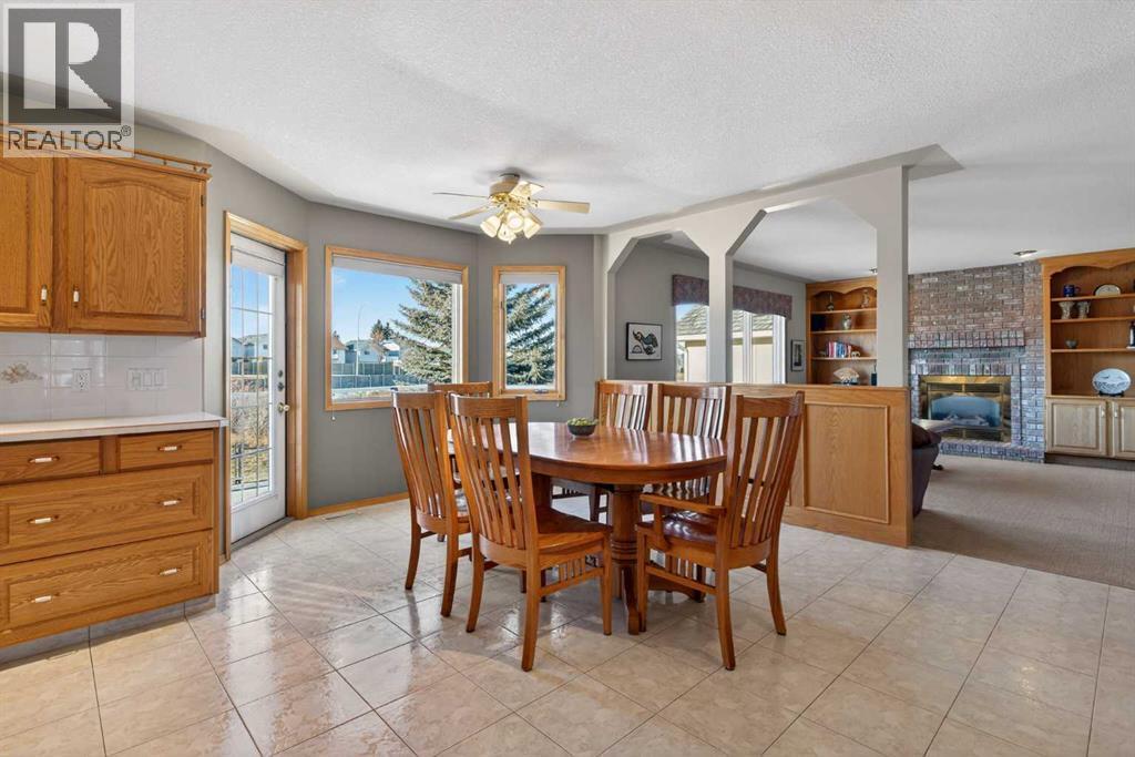 116 Hampshire Grove Nw, Calgary, AB - Indoor Photo Showing Dining Room With Fireplace