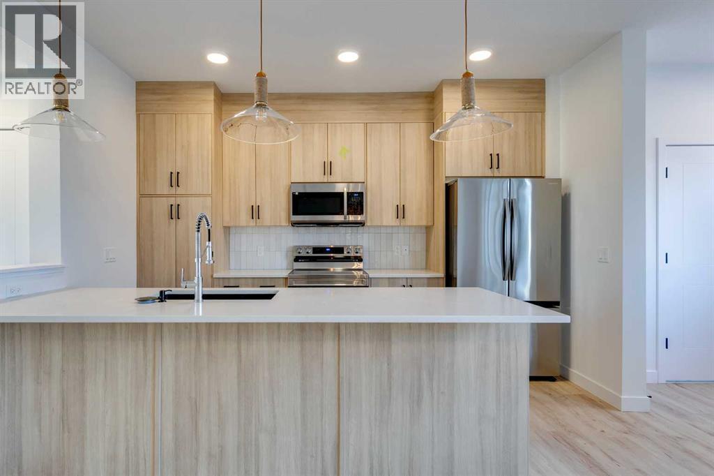 98 Agate Road, Cochrane, AB - Indoor Photo Showing Kitchen With Upgraded Kitchen