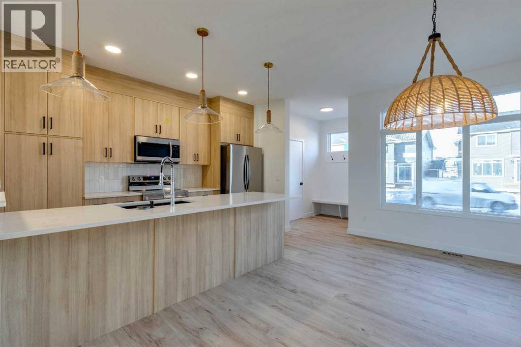 98 Agate Road, Cochrane, AB - Indoor Photo Showing Kitchen With Upgraded Kitchen