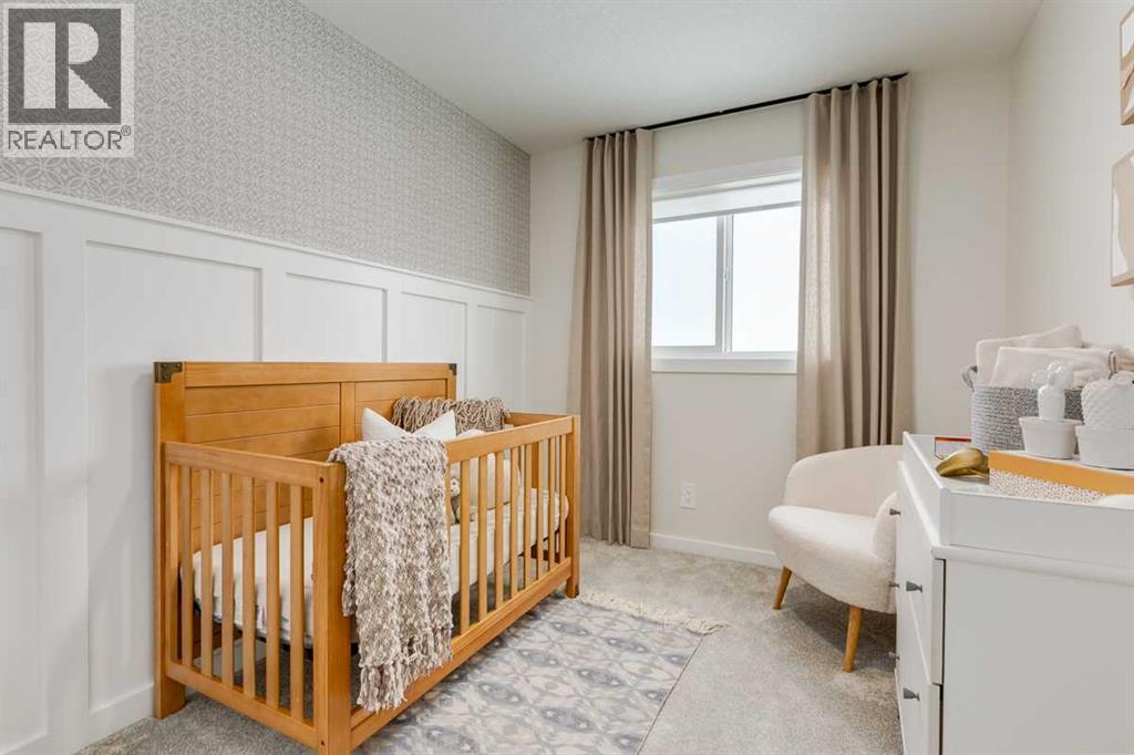 PLEASE NOTE: Photos are of a finished Showhome of the same model – fit and finish may differ on finished spec home. Interior selections and floorplans shown in photos - 62 Starling Boulevard Nw, Calgary, AB - Indoor Photo Showing Bedroom