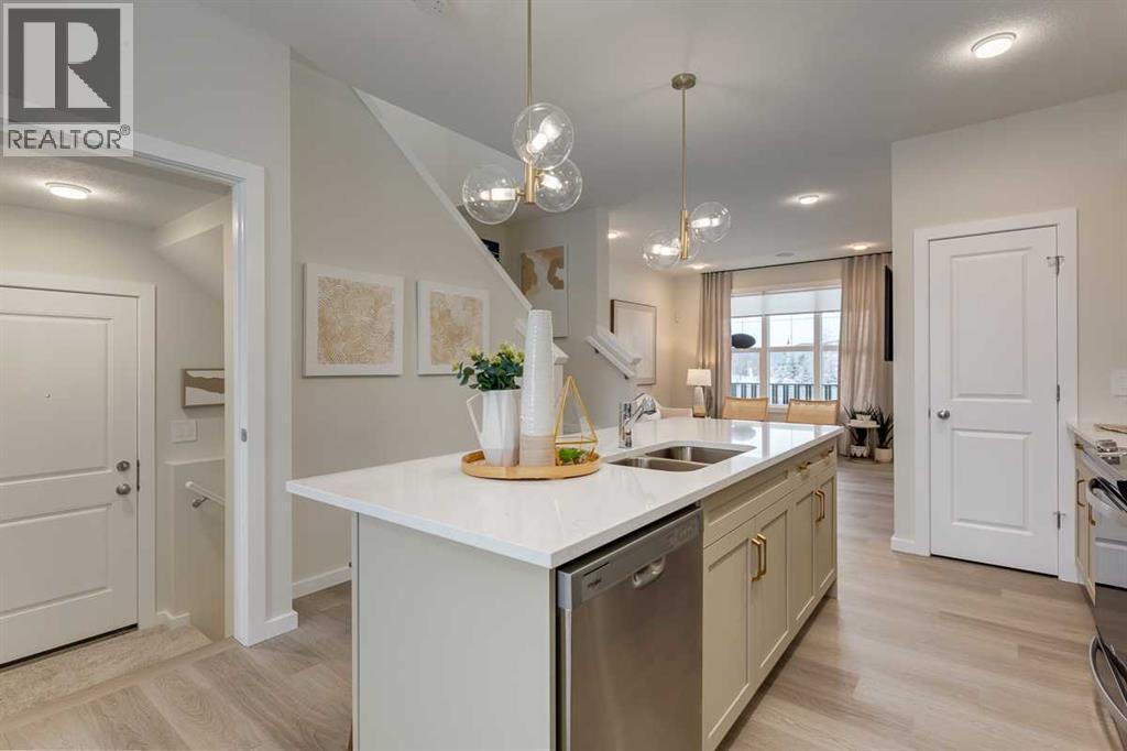 PLEASE NOTE: Photos are of a finished Showhome of the same model – fit and finish may differ on finished spec home. Interior selections and floorplans shown in photos - 62 Starling Boulevard Nw, Calgary, AB - Indoor Photo Showing Kitchen With Double Sink