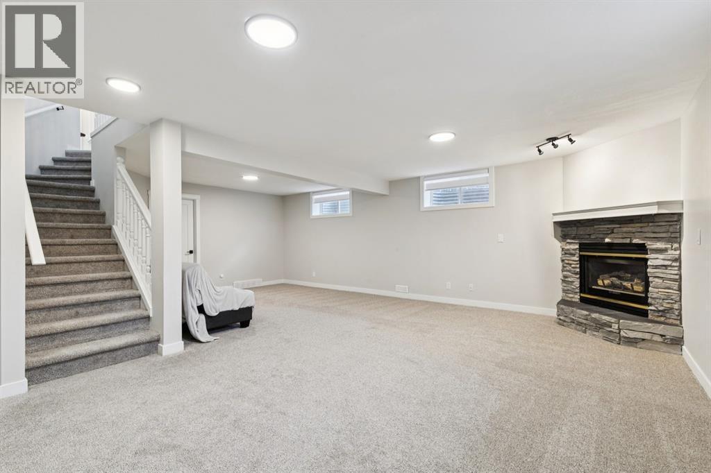 230 Chaparral Place Se, Calgary, AB - Indoor Photo Showing Basement With Fireplace