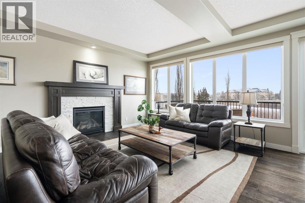 52 Elgin Estates View Se, Calgary, AB - Indoor Photo Showing Living Room With Fireplace