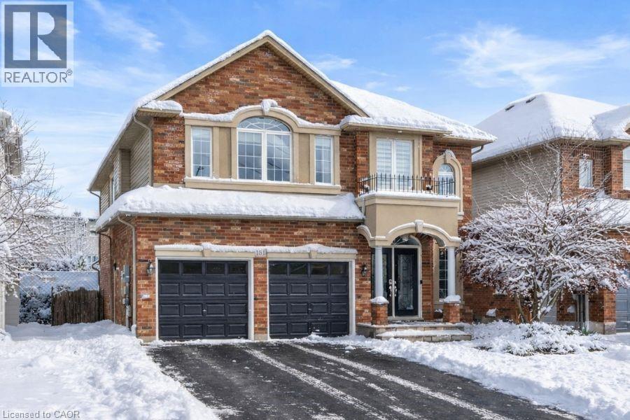 View of front facade featuring a garage, a balcony, and brick siding - 151 Fair Street, Ancaster, ON