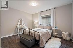 Bedroom featuring dark wood-style floors and a textured ceiling -