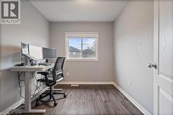 Office featuring dark wood finished floors and baseboards -