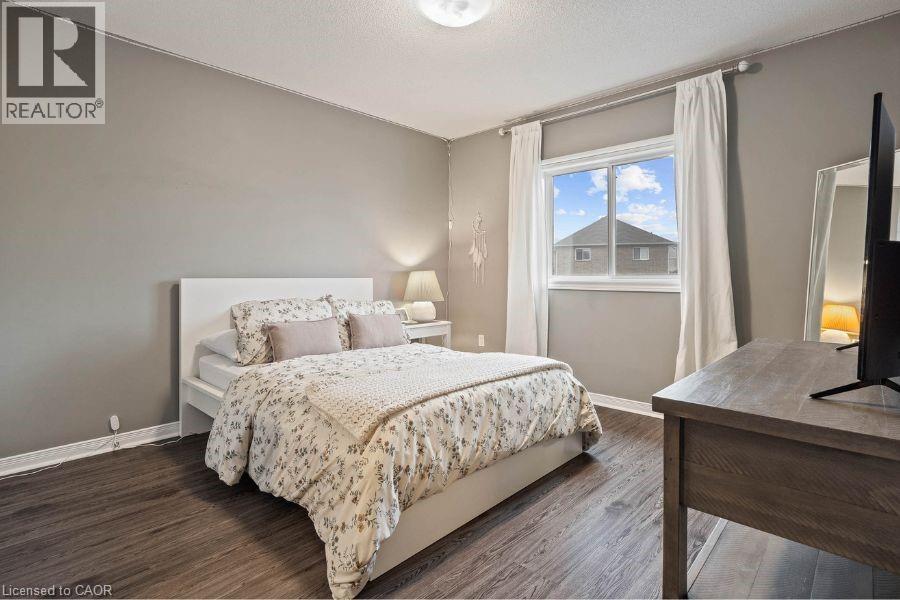 Bedroom with wood finished floors and baseboards - 151 Fair Street, Ancaster, ON