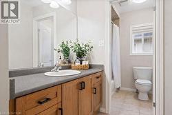 Full bathroom with vanity, shower / bathtub combination with curtain, and light tile patterned floors -