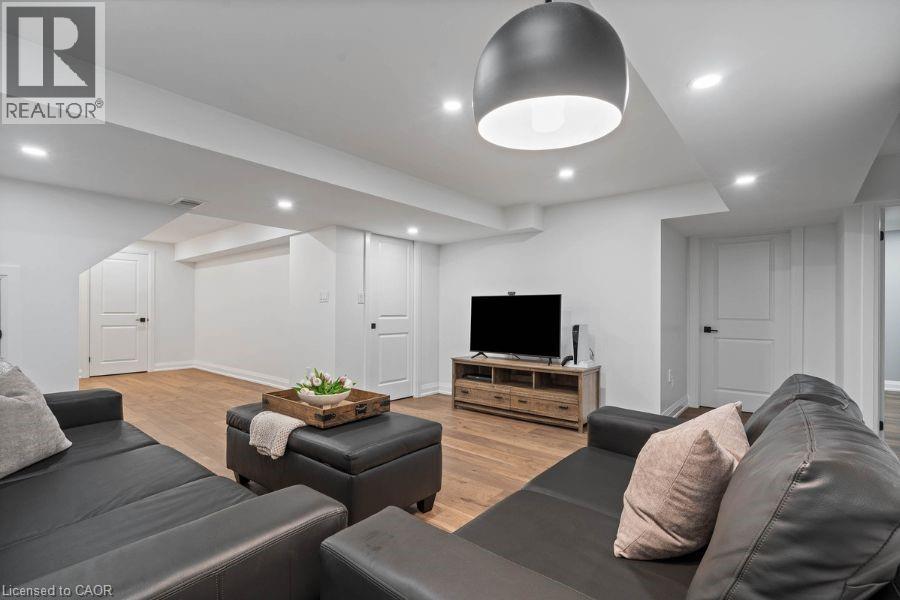 Living room with light wood finished floors and recessed lighting - 151 Fair Street, Ancaster, ON