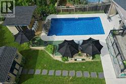 View of swimming pool with a fenced backyard, a patio, and an outdoor structure -