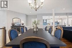 Dining room with recessed lighting, a chandelier, dark wood finished floors, and decorative columns -