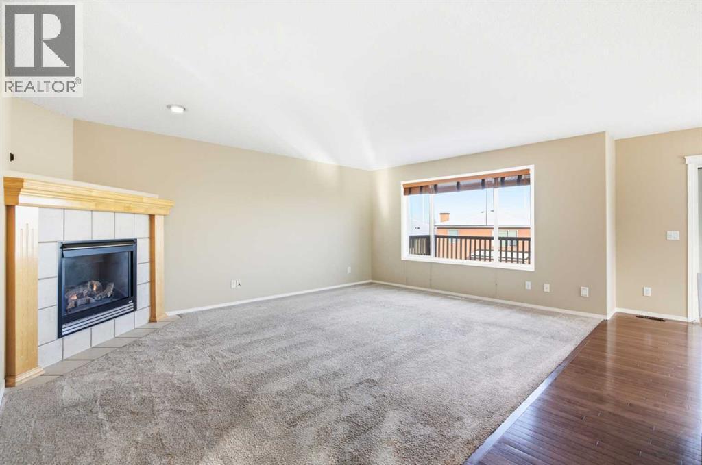 202 Panamount Court Nw, Calgary, AB - Indoor Photo Showing Living Room With Fireplace