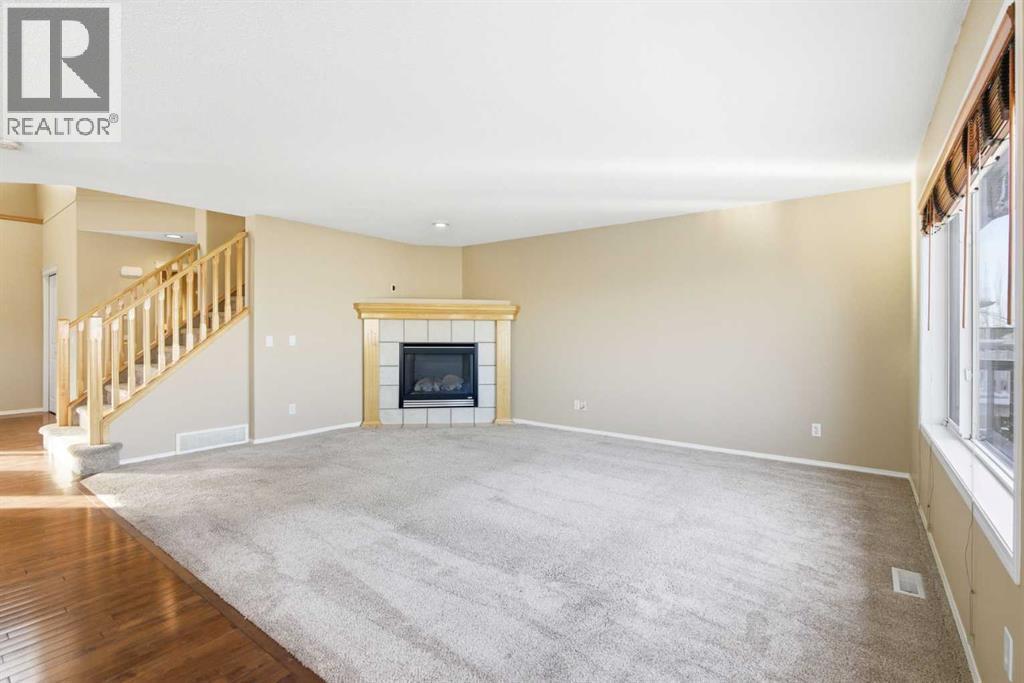 202 Panamount Court Nw, Calgary, AB - Indoor Photo Showing Living Room With Fireplace
