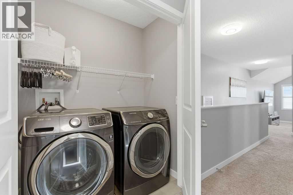 Upper level laundry - 105 Chaparral Valley Crescent Se, Calgary, AB - Indoor Photo Showing Laundry Room