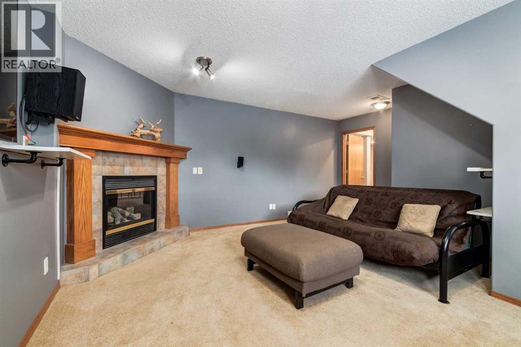 140 Stonegate Close Nw, Airdrie, AB - Indoor Photo Showing Other Room With Fireplace