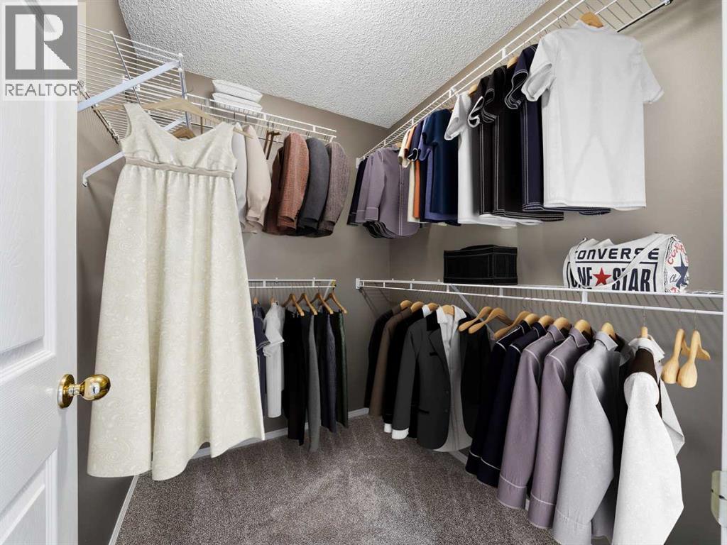Walk-in Closet (virtually staged) - 626 Hawkstone Manor Nw, Calgary, AB - Indoor With Storage